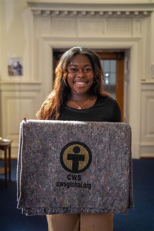 Belinda A., Community Engagement Specialist at Church World Service, holds a CWS Blanket—made possible by the generosity of congregations and donors. Belinda A., Community Engagement Specialist at Church World Service, holds a CWS Blanket—made possible by the generosity of congregations and donors.